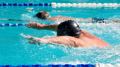Person in swimming pool performing butterfly stroke
