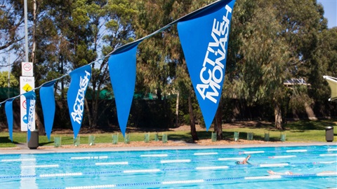 Swimming pool with safety flags in focus