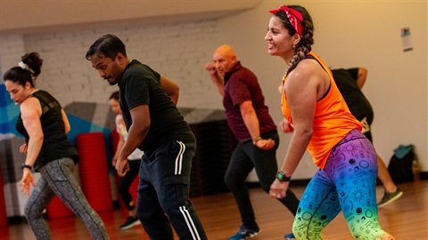 Group of people dancing in group fitness class