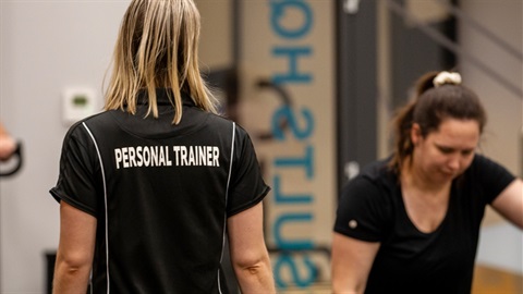 Personal trainer instructing clients