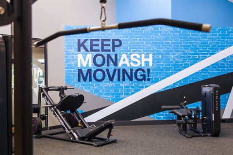 Gym equipment with wall graphic saying keep on moving