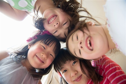 Kids looking down smiling to camera