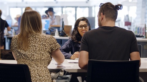 Two young people discussing membership options with Active Monash staff members