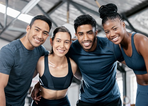 Group of friends in the gym posing for a group photo.jpg