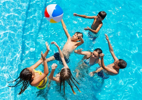 Kids playing in pool with inflatable beach ball.jpeg