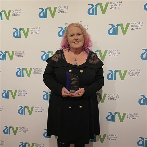 Imelda holding ARV Award.png