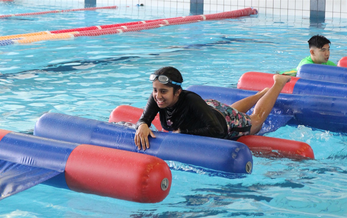 Girl on inflatable log runner.jpg