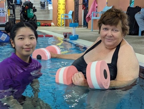 Participant in pool with instructor.jpg