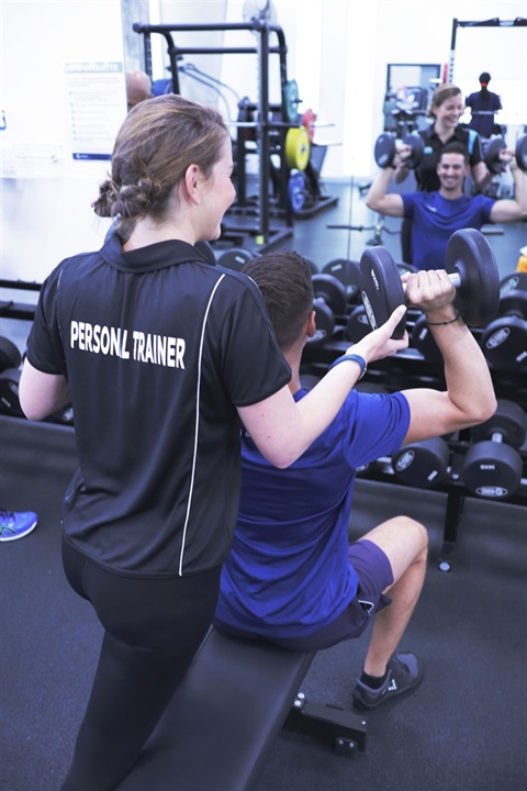 Personal Trainer helping a client exercise.jpg