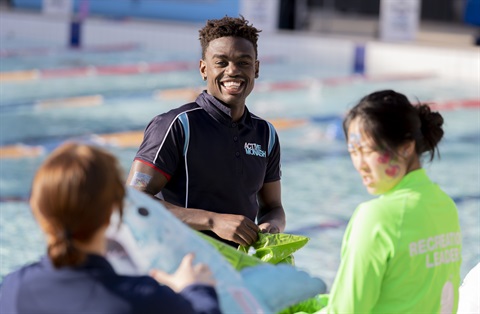 Staff member smiling in front of the pool.png